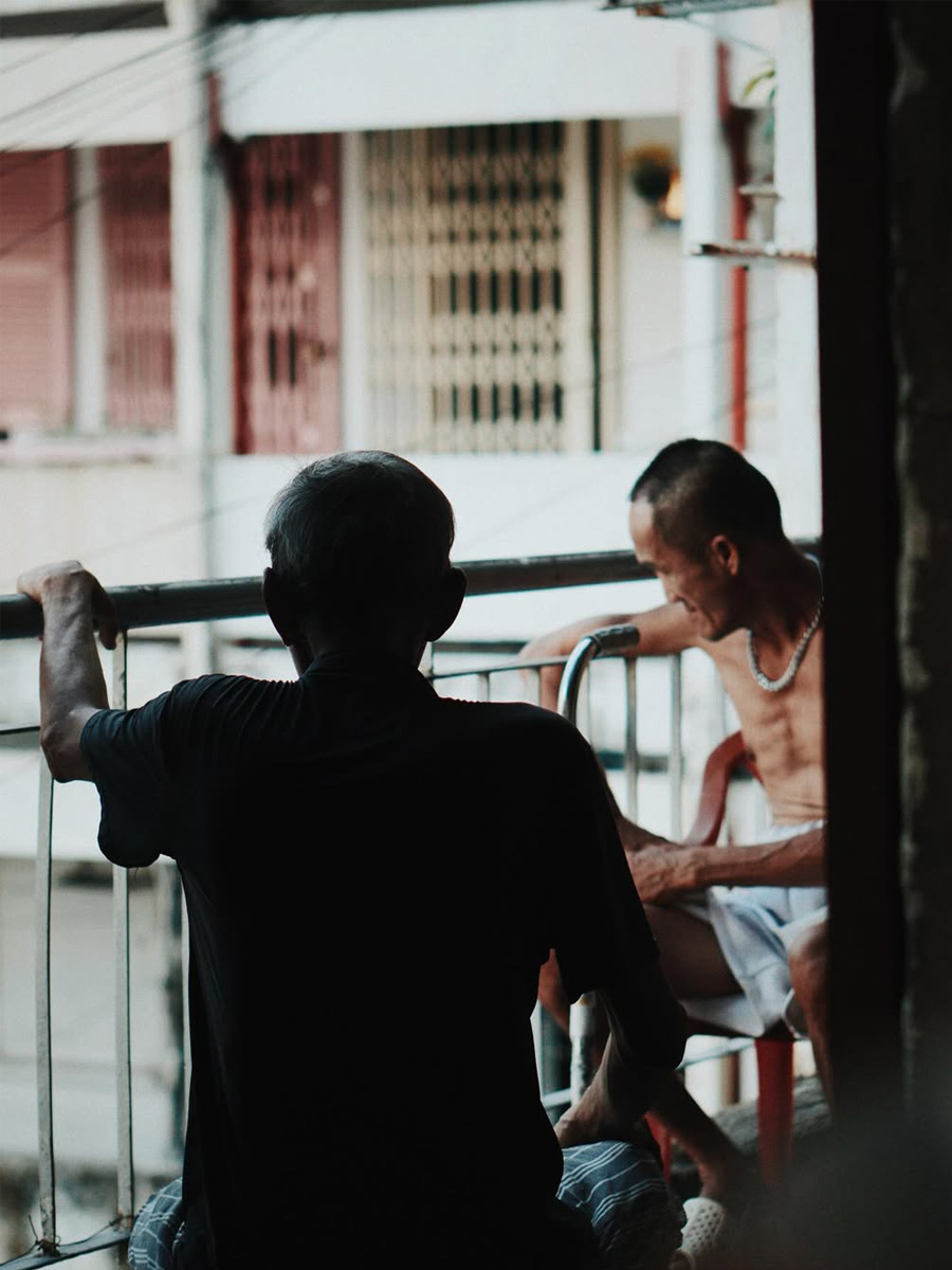 Two man are having a conversation on the balcony